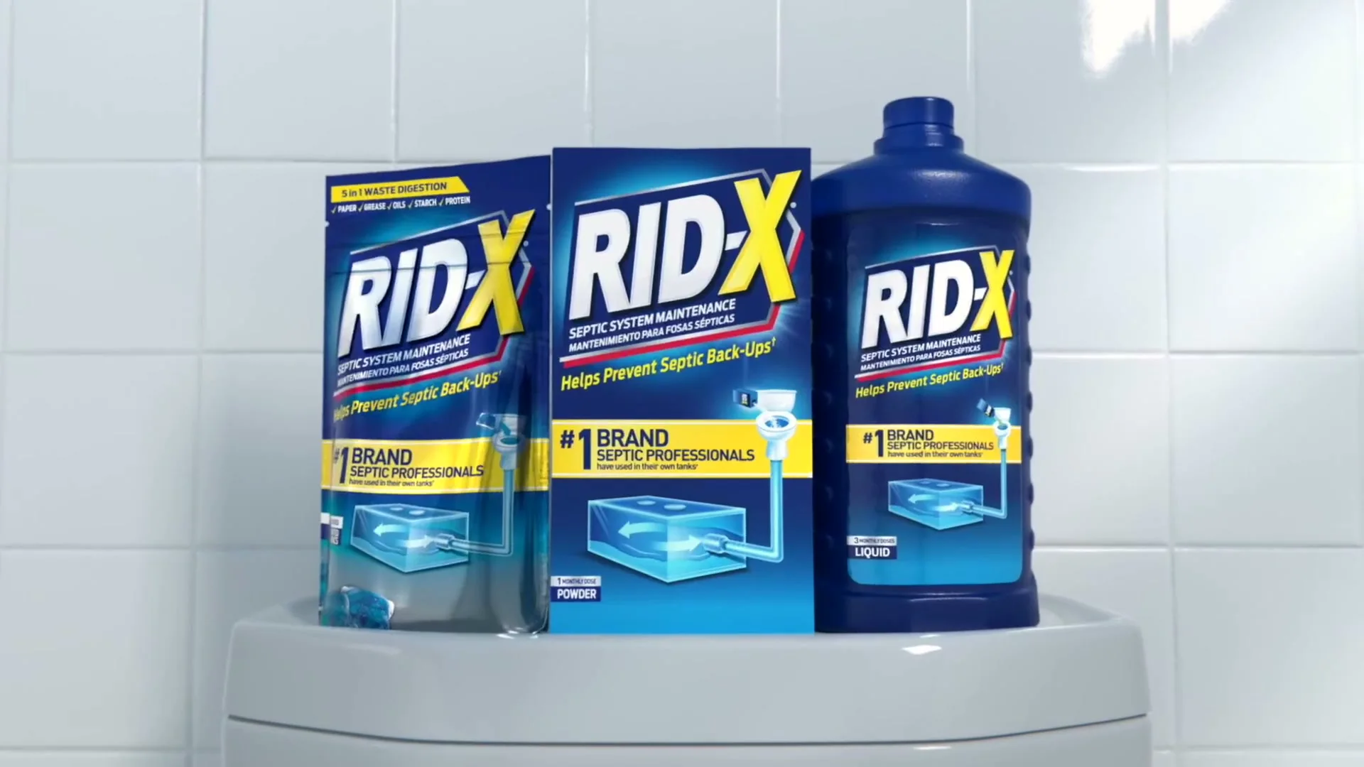 Rid-X boxes and a Platinum bottle on a toilet tank. A still from a Rid-X commercial.